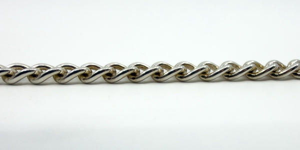 Side profile photo of sterling silver curb chain links showing thickness and rounded edges.