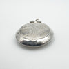 Depth and structure of sterling silver engraved secret locket shown from side