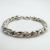 Side profile showing the thick, polished twisted links in sterling silver