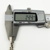 Digital caliper measuring the vintage sterling silver curb bracelet link depth at approximately 1.44mm.