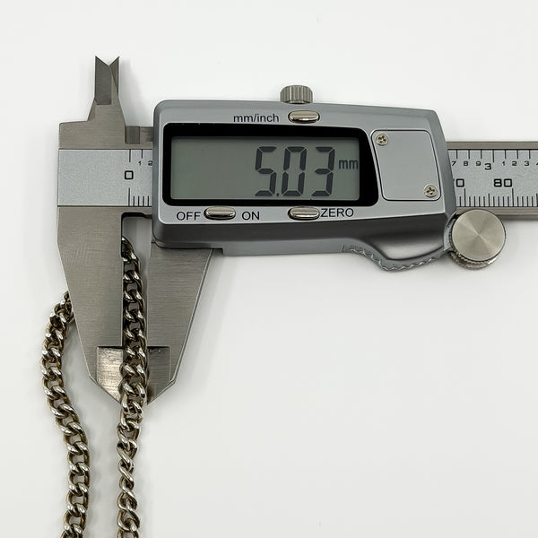 Digital caliper measuring the vintage sterling silver curb bracelet link at approximately 5.03mm wide.