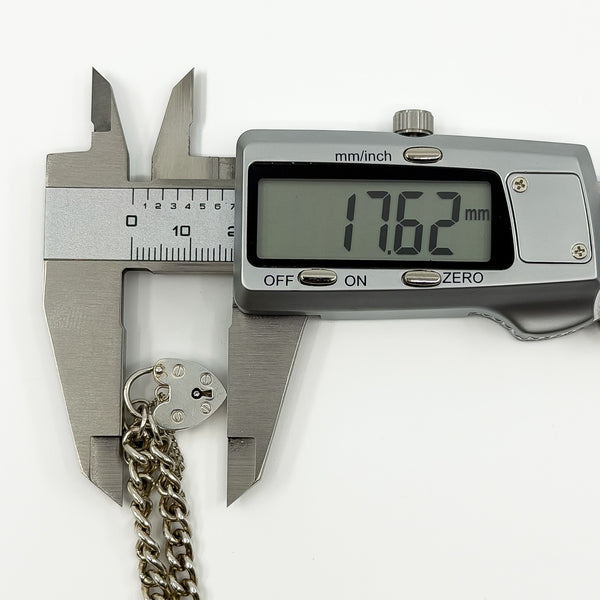 Digital caliper measuring the sterling silver heart padlock at approximately 17.62mm.