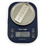 Vintage sterling silver ingot pendant shown weighing approximately 30.44g on digital scales