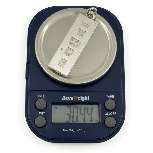 Vintage sterling silver ingot pendant shown weighing approximately 30.44g on digital scales