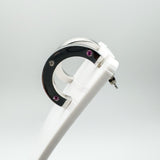 Single earring shown on white display, highlighting bezel set stones and polished silver finish