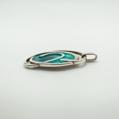 Slim side view of preloved sterling silver green enamel pendant
