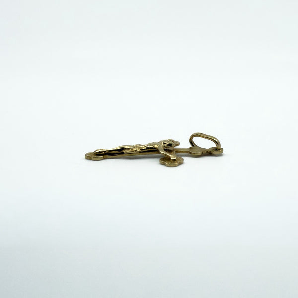 Side view of a small vintage 9ct gold crucifix cross pendant charm with raised figure detail