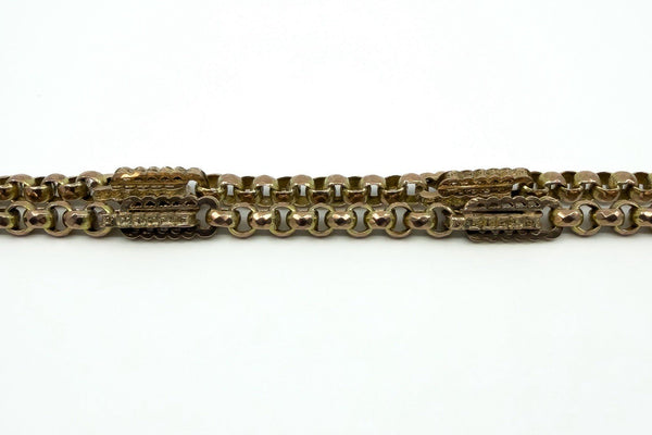 Close view of fancy links on an antique 9ct rose gold Albert chain, showing soldered link detail