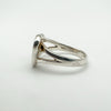 Close up side view of sterling silver ring with split band under heart stone