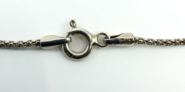 Close-up of sterling silver chain spring ring clasp showing 925 stamp and Italy mark on the end tab.