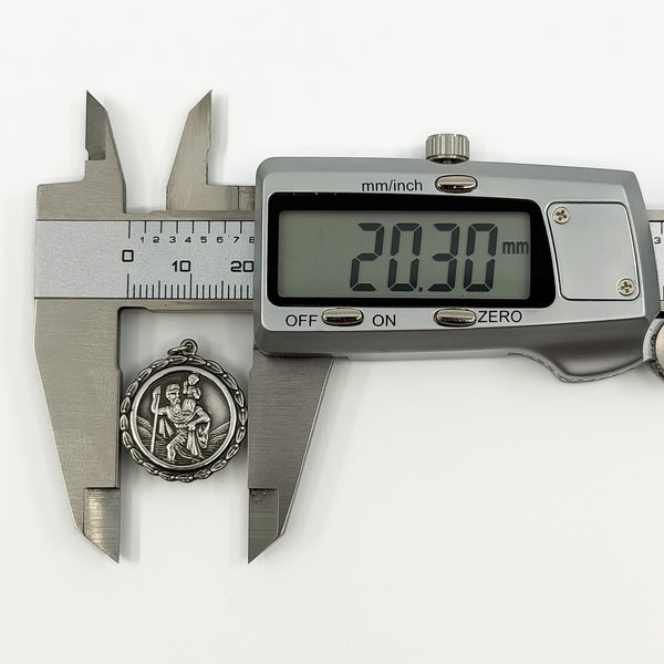 Digital caliper measuring the vintage sterling silver St Christopher pendant at approximately 20.30mm.