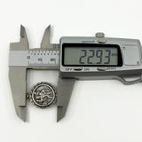 Digital caliper measuring the vintage sterling silver St Christopher pendant at approximately 22.93mm.