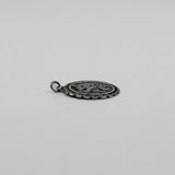 Low side view of vintage sterling silver St Christopher pendant charm showing its slim profile.