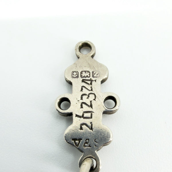 Close-up of a sterling silver St Johns Ambulance award bar showing maker, Birmingham and silver hallmarks.