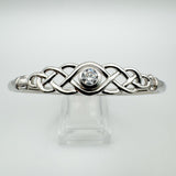 Celtic bangle with brilliant-cut CZ shown on clear display stand