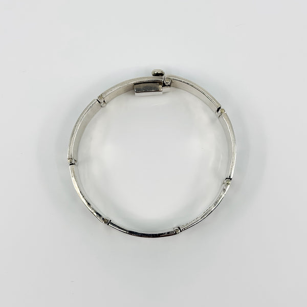 Open underside of the sterling silver turquoise bracelet showing hinged panel construction and clasp fitting