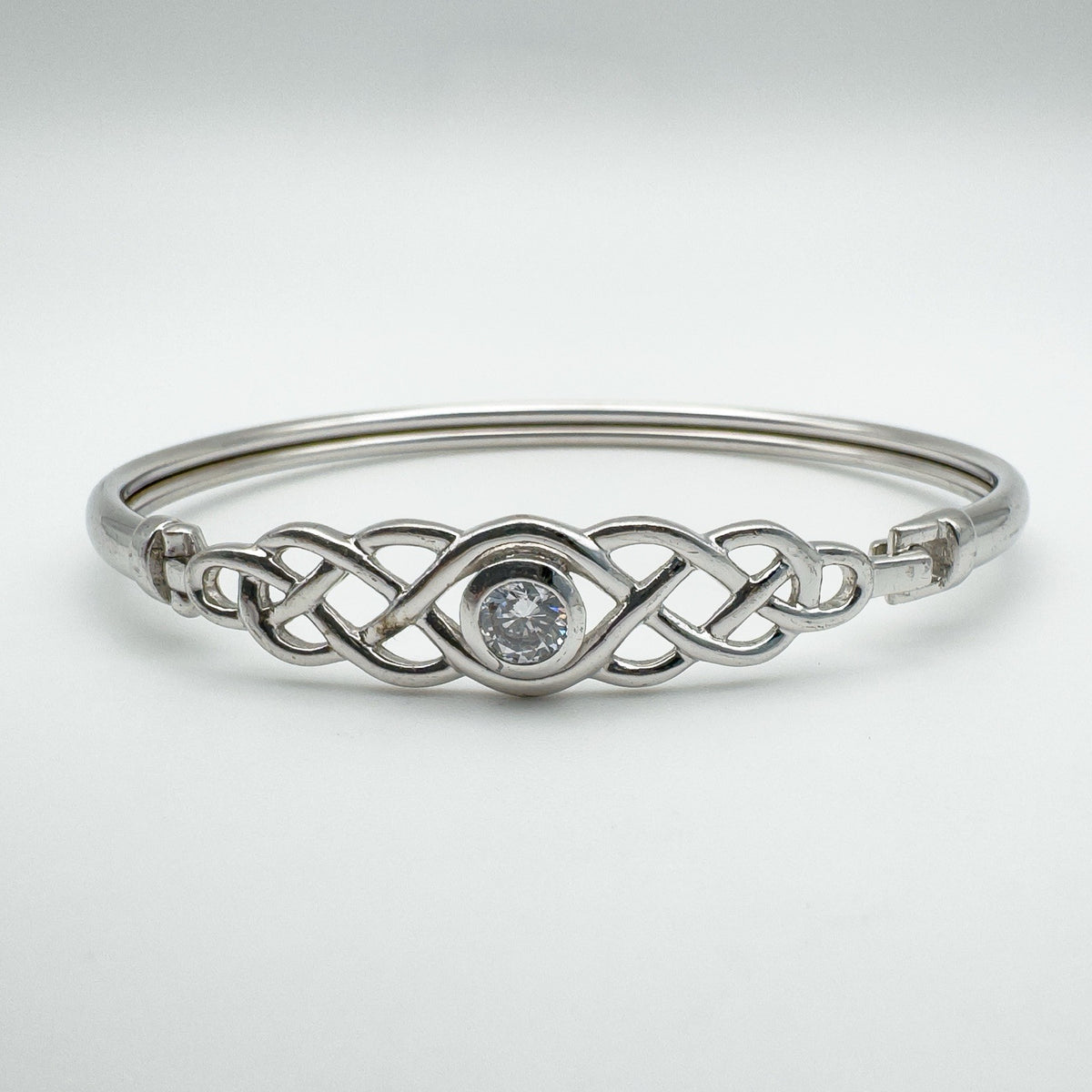 Front view of sterling silver Celtic knot bangle with central cubic zirconia stone