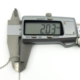 Close up of sterling silver chain links shown with caliper measurement of approximately 2mm