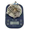 Vintage sterling silver charm bracelet on digital scales showing an approximate weight of 30.86g.