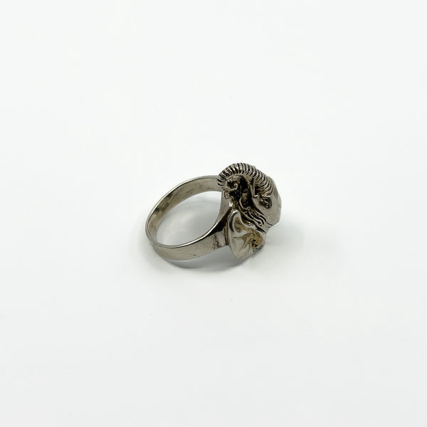 Side view of vintage sterling silver elephant locket ring showing raised trunk, ear and wide band