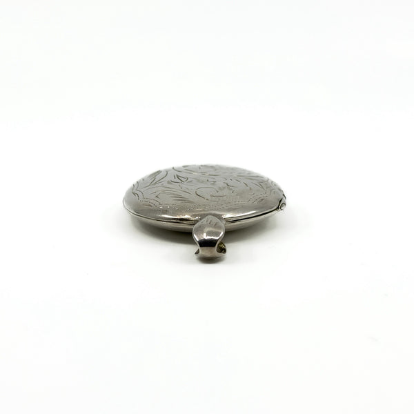Low side view of the sterling silver engraved oval locket showing the rounded edge