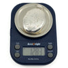 Vintage sterling silver oval engraved photo locket shown weighing 12.83g on digital scales