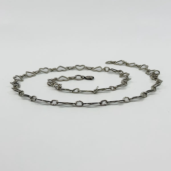 Vintage sterling silver open heart necklace shown from the side with shaped heart links