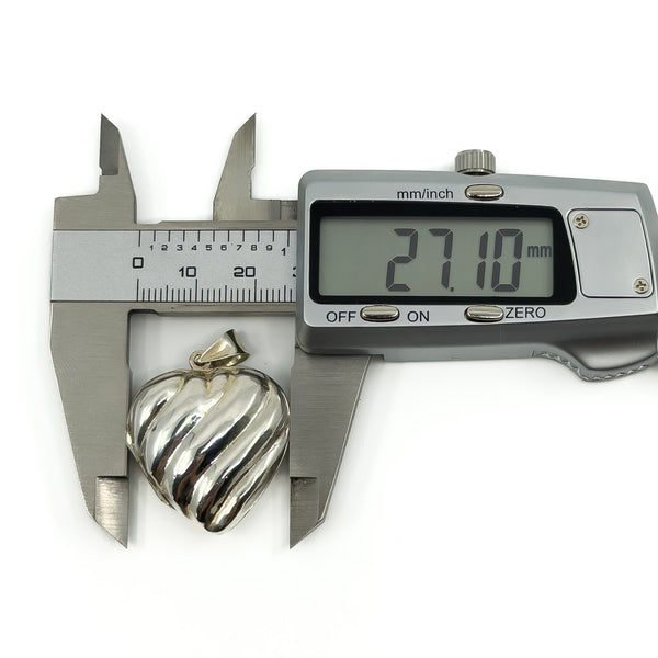 Digital calipers measuring the puffy heart sterling silver locket at approximately 27.1mm wide