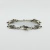 Low side view of vintage sterling silver horsebit snaffle bracelet showing the link profile.