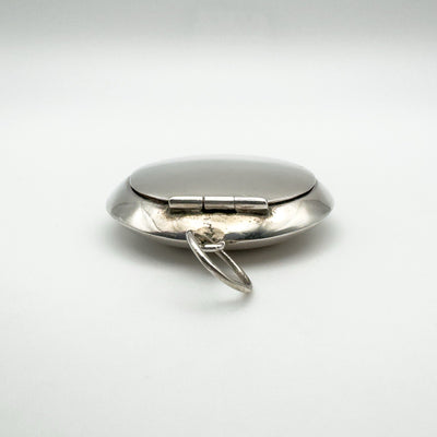 Hinged sterling silver pill box locket with visible bail for necklace chain