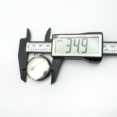 Vintage mirrored silver pendant measured at 34.9mm with digital caliper