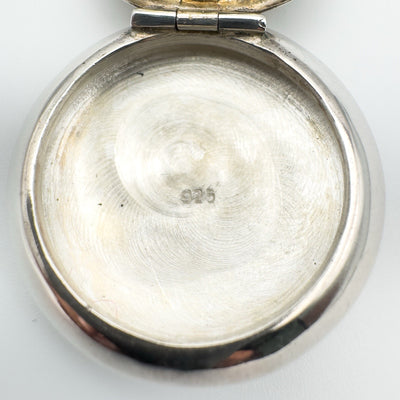 Close-up of 925 stamp inside sterling silver mirrored locket