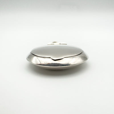 Front view of closed sterling silver pill box style locket pendant