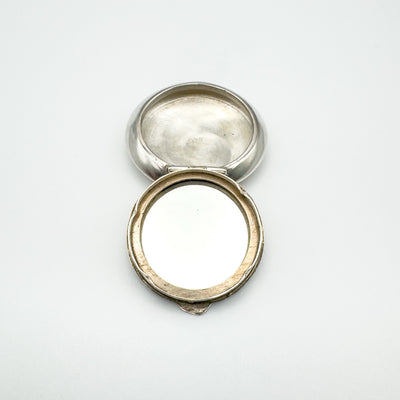 Open vintage sterling silver pendant showing circular mirror and interior