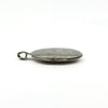 Side view of the sterling silver oval photo locket showing the hinge and engraved front