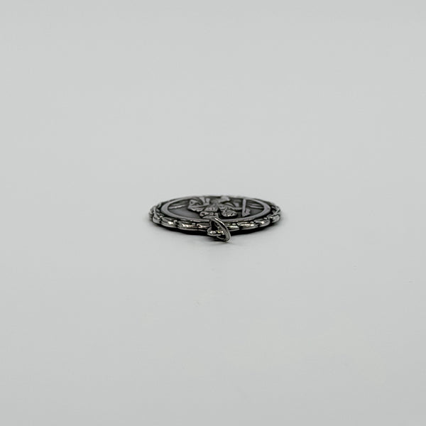 Side view of vintage sterling silver St Christopher pendant charm showing the jump ring fitting.