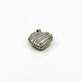 Angled view of the vintage sterling silver puffy heart locket with polished ridged front.