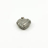 Angled view of the vintage sterling silver puffy heart locket with polished ridged front.