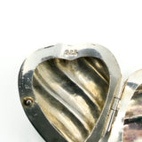 Close up of the 925 stamp inside the sterling silver puffy heart photo locket.