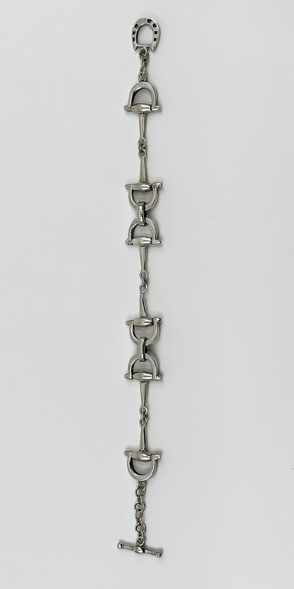 Vintage sterling silver horsebit snaffle bracelet laid straight to show the full 7.5 inch length.