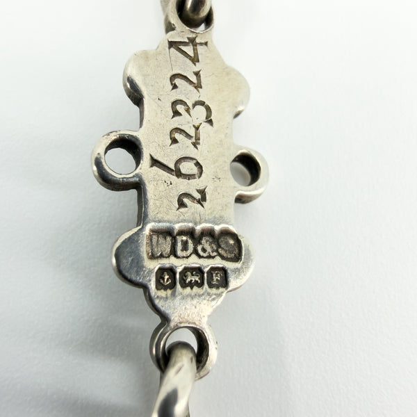 Close-up of a sterling silver examination bar showing maker and Birmingham assay marks with number 262324.