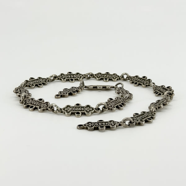Low angled view of the Art Deco St Johns Ambulance watch chain showing the linked dated sterling silver award bars.