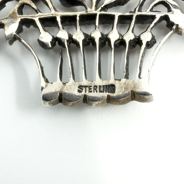 Close-up of STERLING stamp on the giardinetti basket brooch in sterling silver.