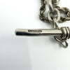 Close-up of the sterling silver T-bar showing stamped maker’s mark and chain links
