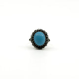 Sterling silver ring with oval turquoise and natural diamond halo setting