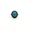 Sterling silver ring with oval turquoise and natural diamond halo setting
