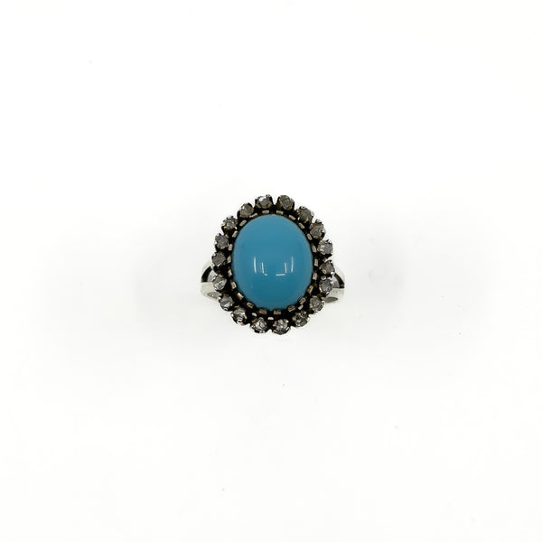 Front view of the turquoise cabochon and rough cut diamond halo ring