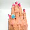 Sterling silver turquoise navette ring modelled on finger with pink nails