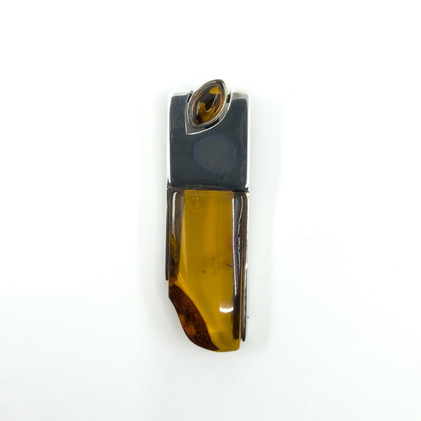 Sterling silver amber pendant front view on white background.