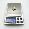 Digital scale showing sterling silver bee pendant weighs 2.4 grams